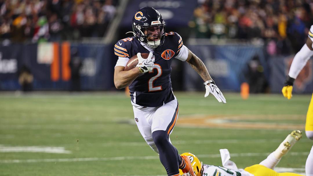 Dec 20, 2025; Chicago, Illinois, USA; Chicago Bears wide receiver DJ Moore (2) runs after the catch against Green Bay Packers guard Lecitus Smith (68) during the first quarter at Soldier Field