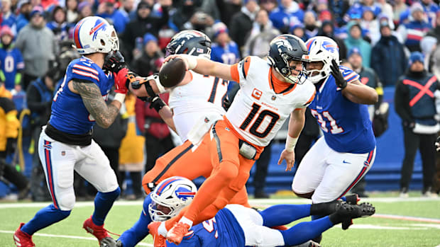 Jan 12, 2025; Orchard Park, New York, USA; Denver Broncos quarterback Bo Nix (10) runs out of the pocket during the fourth qu