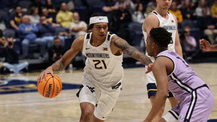 West Virginia University guard RaeQuan Battle drives past Kansas State guard Tylor Perry in the first half at the WVU Coliseum. 