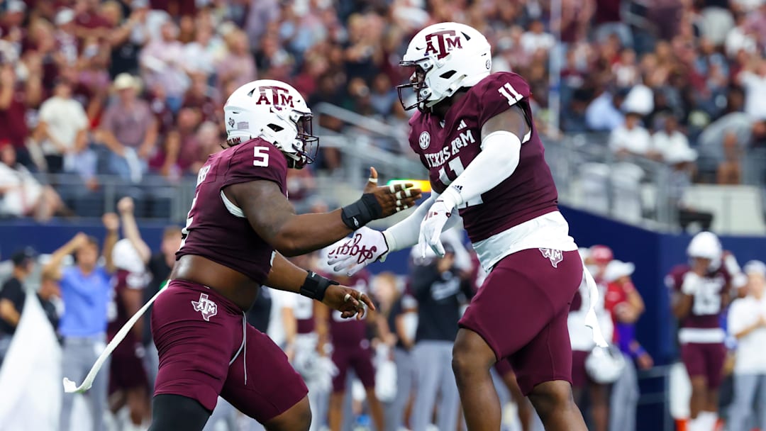 Sep 28, 2024; Arlington, Texas, USA;  Texas A&M Aggies defensive lineman Nic Scourton (11) celebrates with Texas A&M Aggies defensive lineman Shemar Turner (5) during the first half against the Arkansas Razorbacks at AT&T Stadium. Mandatory Credit: Kevin Jairaj-Imagn Images