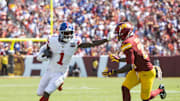 Sep 15, 2024; Landover, Maryland, USA; New York Giants wide receiver Malik Nabers (1) runs down the field pressured by Washington Commanders defensive back Juan Martin (20) in the first half at Commanders Field.  