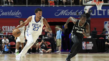 Jul 10, 2025; Las Vegas, NV, USA; Philadelphia 76ers Keve Aluma (27) dribbles past San Antonio Spurs forward David Jones-Garcia (25) in the second quarter of their game at Thomas & Mack Center. Mandatory Credit: Candice Ward-Imagn Images