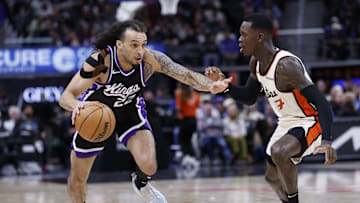 Apr 7, 2025; Detroit, Michigan, USA;  Sacramento Kings guard Devin Carter (22) dribbles defended by Detroit Pistons guard Dennis Schroder (17) in the first half at Little Caesars Arena. Mandatory Credit: Rick Osentoski-Imagn Images