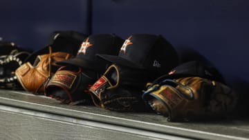 Aug 4, 2023; Bronx, New York, USA; Houston Astros gloves and hats rest in the dug out during the third inning against the New York Yankees at Yankee Stadium. Vincent Carchietta-USA TODAY Sports