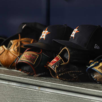 Aug 4, 2023; Bronx, New York, USA; Houston Astros gloves and hats rest in the dug out during the third inning against the New York Yankees at Yankee Stadium.