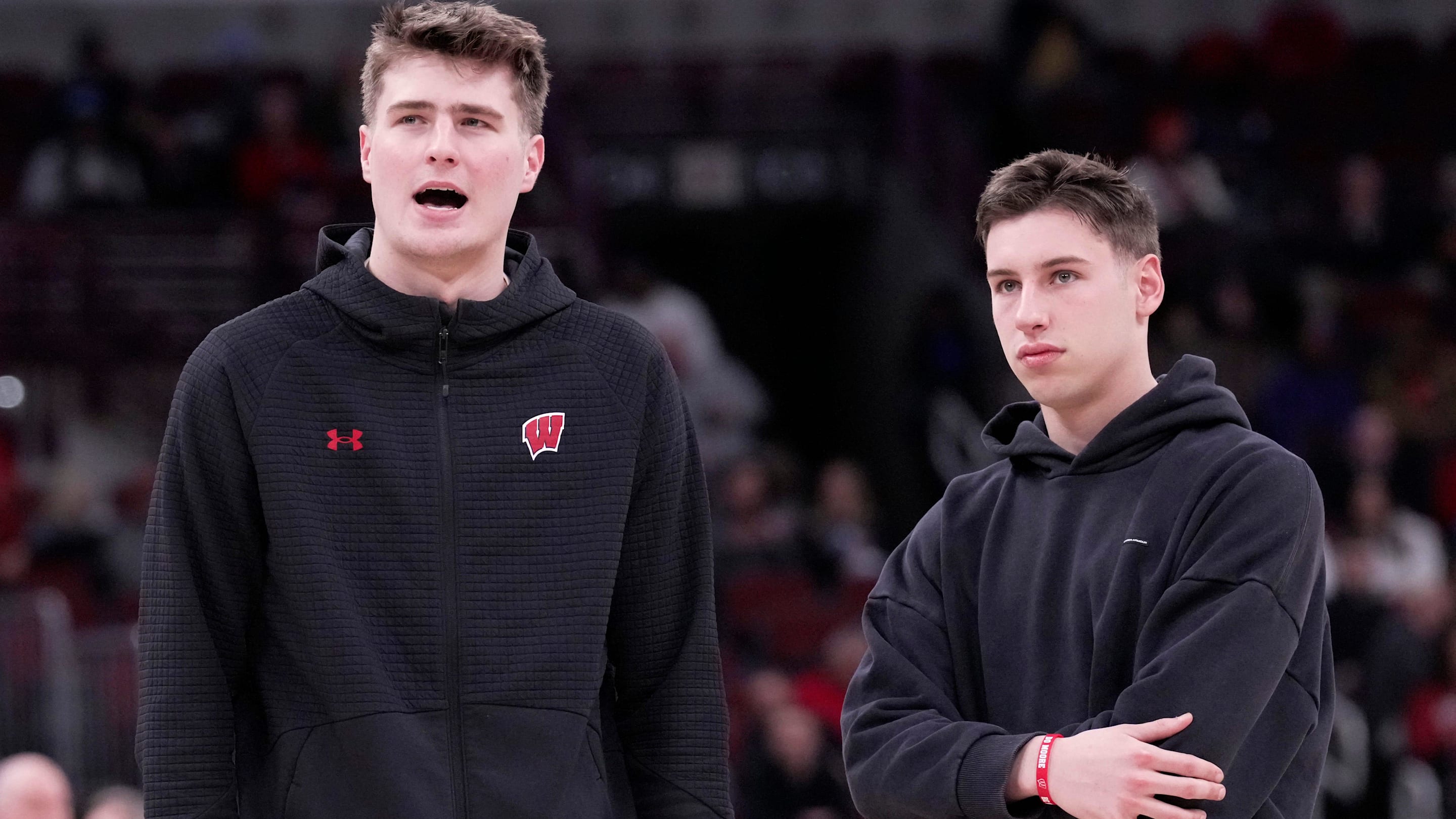 Injured Wisconsin forward Nolan Winter, left, talks with injured guard Jack Janicki before the second half of their third round game of the Big Ten tournament Thursday, March 12, 2026 at the United Center in Chicago, Illinois. Wisconsin beat Washington 85-82.