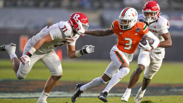 Dec 28, 2023; Bronx, NY, USA; Miami Hurricanes wide receiver Jacolby George (3) runs with the ball chased by Rutgers Scarlet Knights defensive lineman Aaron Lewis (71) during the third quarter at Yankee Stadium. Mandatory Credit: Mark Smith-USA TODAY Sports