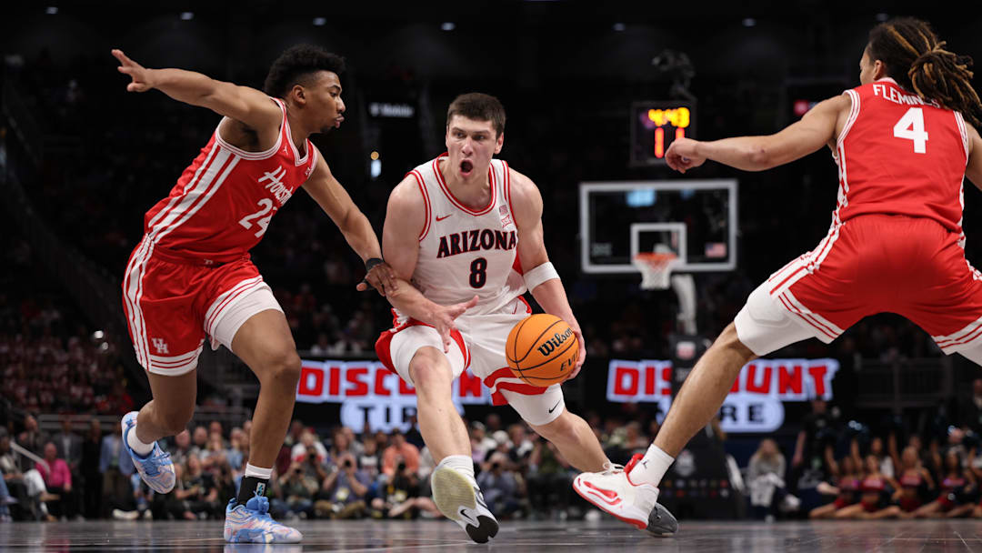 Mar 14, 2026; Kansas City, MO, USA; Arizona Wildcats forward Ivan Kharchenkov (8) drives to the hoop past Houston Cougars forward Chase McCarty (24) and guard Kingston Flemings (4) during the first half during the men's Big 12 Conference Tournament Championship at T-Mobile Center.