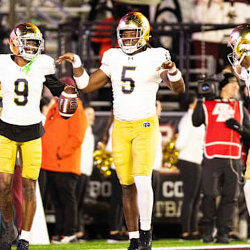 Nov 1, 2025; Chestnut Hill, Massachusetts, USA; Notre Dame safety Tae Johnson (9) and Notre Dame Fighting Irish defensive lineman Boubacar Traore (5) celebrate an interception in the fourth quarter against the Boston College Eagles at Alumni Stadium. Mandatory Credit: Edward Finan-Imagn Images