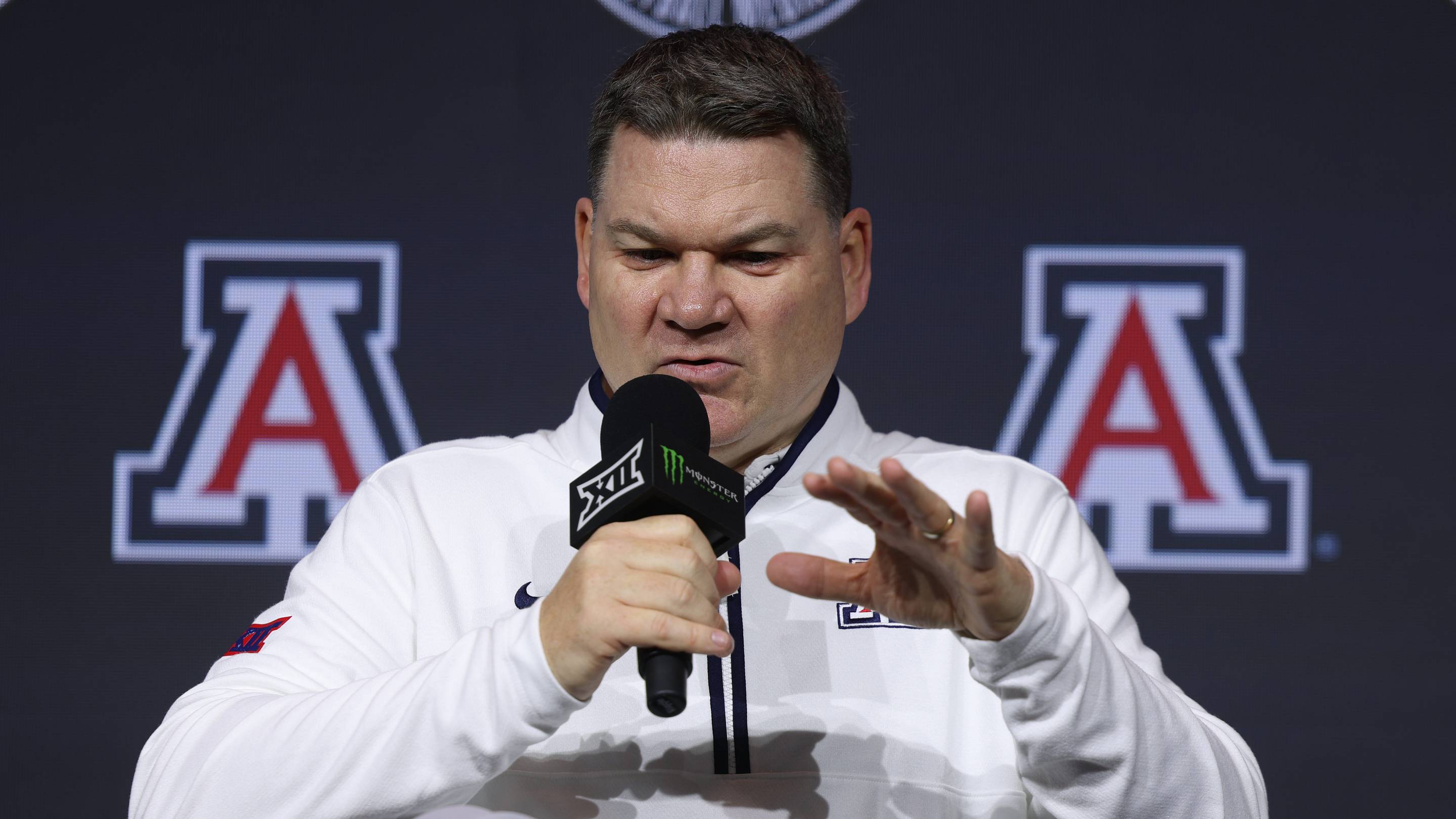 Oct 21, 2026; Kansas City, MO, USA; Arizona coach Tommy Lloyd is interviewed during the Big 12 Media Days at T-Mobile Center. | IMAGN IMAGES via Reuters Connect