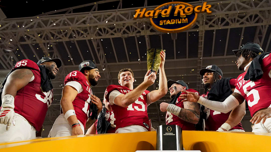 Indiana Hoosiers quarterback Fernando Mendoza (15) hoists the championship trophy Monday, Jan. 19, 2026, after defeating the Miami (FL) Hurricanes in the College Football Playoff National Championship college football game at Hard Rock Stadium in Miami Gardens.