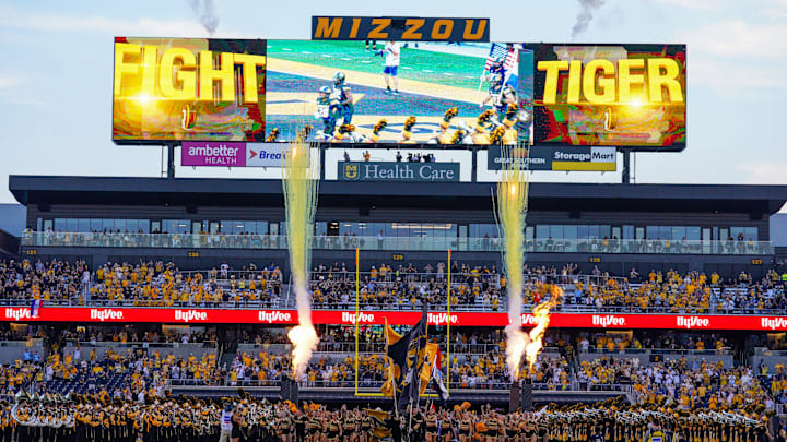 Aug 29, 2024; Columbia, Missouri, USA; Missouri Tigers cheerleaders run on field ahead of players against the Murray State Racers prior to a game at Faurot Field at Memorial Stadium. 