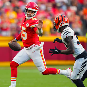 Sep 15, 2024; Kansas City, Missouri, USA; Kansas City Chiefs quarterback Patrick Mahomes (15) runs the ball against Cincinnati Bengals cornerback Dax Hill (23) during the first half at GEHA Field at Arrowhead Stadium. Mandatory Credit: Jay Biggerstaff-Imagn Images