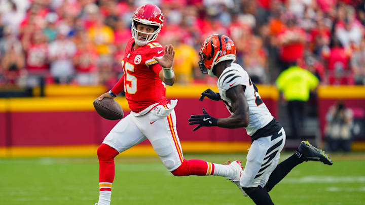 Sep 15, 2024; Kansas City, Missouri, USA; Kansas City Chiefs quarterback Patrick Mahomes (15) runs the ball against Cincinnati Bengals cornerback Dax Hill (23) during the first half at GEHA Field at Arrowhead Stadium. Mandatory Credit: Jay Biggerstaff-Imagn Images