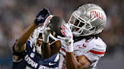 UNLV Rebels wide receiver Ricky White III (11) catches a touchdown pass in front of Utah State Aggies cornerback Avante Dickerson (17) in the first half at Merlin Olsen Field at Maverik Stadium. 