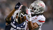 UNLV Rebels wide receiver Ricky White III (11) catches a touchdown pass in front of Utah State Aggies cornerback Avante Dickerson (17) in the first half at Merlin Olsen Field at Maverik Stadium. Mandatory Credit: Jamie Sabau-Imagn Images
