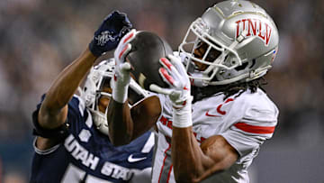 UNLV Rebels wide receiver Ricky White III (11) catches a touchdown pass in front of Utah State Aggies cornerback Avante Dickerson (17) in the first half at Merlin Olsen Field at Maverik Stadium. Mandatory Credit: Jamie Sabau-Imagn Images