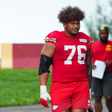 Jul 22, 2025; St. Joseph, MO, USA; Kansas City Chiefs guard Trey Smith (65) and offensive tackle Kingsley Suamataia (76) walk down the hill to the practice fields during training camp at Missouri Western State University. Mandatory Credit: Denny Medley-Imagn Images