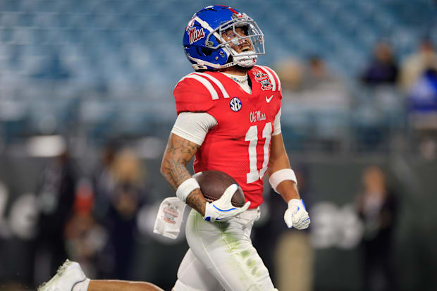 Mississippi Rebels wide receiver Jordan Watkins (11) smiles as he scores a touchdown during the fourth quarter of the TaxSlay