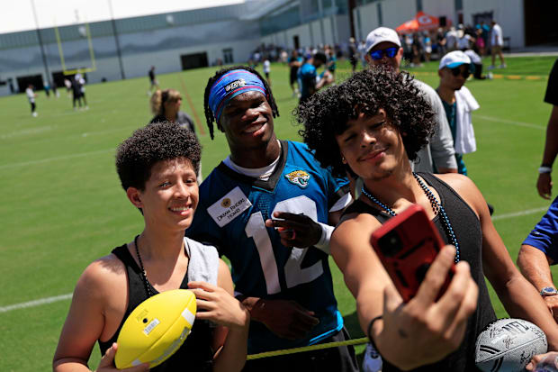 Jacksonville Jaguars wide receiver Travis Hunter (12), center, takes a selfie with brothers JJ Rivera, 14, left, and Gary DeL