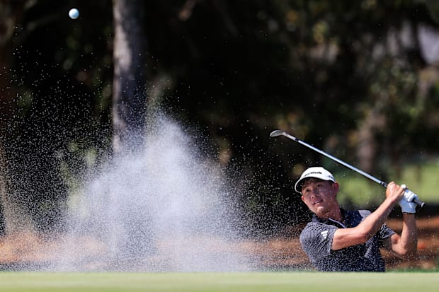 Collin Morikawa chips out of the bunker
