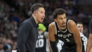 Dec 29, 2024; Minneapolis, Minnesota, USA; San Antonio Spurs interim head coach Mitch Johnson talks with center Victor Wembanyama (1) and guard Tre Jones (33) during a free throw against the Minnesota Timberwolves in the second half at Target Center. Mandatory Credit: Jesse Johnson-Imagn Images