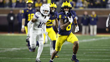 Nov 23, 2024; Ann Arbor, Michigan, USA;  Michigan Wolverines wide receiver Tyler Morris (8) runs the ball against the Northwestern Wildcats in the second half at Michigan Stadium. Mandatory Credit: Rick Osentoski-Imagn Images