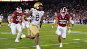 Sep 13, 2025; Stanford, California, USA; Boston College Eagles running back Turbo Richard (2) runs after a catch against Stanford Cardinal safety Mitch Leigber (32) to score a touchdown during the second quarter at Stanford Stadium. Mandatory Credit: Darren Yamashita-Imagn Images