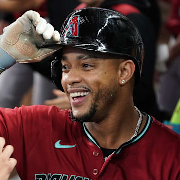 Aug 13, 2025; Arlington, Texas, USA; Arizona Diamondbacks second baseman Ketel Marte (4) is greet in the dugout after hitting a three-run home run during the ninth inning against the Texas Rangers at Globe Life Field. Mandatory Credit: Raymond Carlin III-Imagn Images
