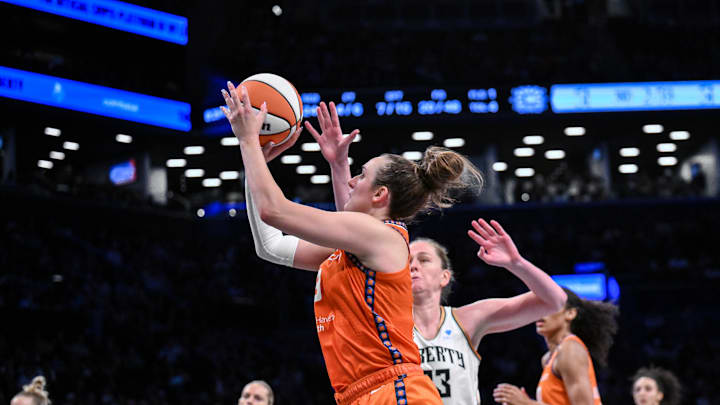 Aug 25, 2025; Brooklyn, New York, USA; Connecticut Sun guard Marina Mabrey (3) shoots the ball while defended by New York Liberty center Emma Meesseman (33) during the second half at Barclays Center. 