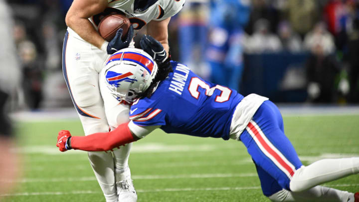 Nov 13, 2023; Orchard Park, New York, USA; Denver Broncos tight end Adam Trautman (82) is tackled by Buffalo Bills safety Damar Hamlin (3) in the fourth quarter at Highmark Stadium. 