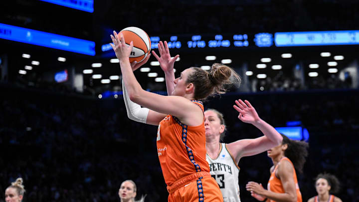 Aug 25, 2025; Brooklyn, New York, USA; Connecticut Sun guard Marina Mabrey (3) shoots the ball while defended by New York Liberty center Emma Meesseman (33) during the second half at Barclays Center. 