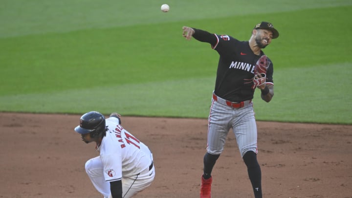 May 18, 2024; Cleveland, Ohio, USA; Minnesota Twins shortstop Carlos Correa (4) turns a double play beside Cleveland Guardians third baseman Jose Ramirez (11) in the fifth inning at Progressive Field.