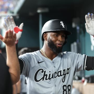 Chicago White Sox center fielder Luis Robert Jr. (88) celebrates with teammates in the dugout after hitting a home run during the third inning against the Texas Rangers at Globe Life Field in 2024.