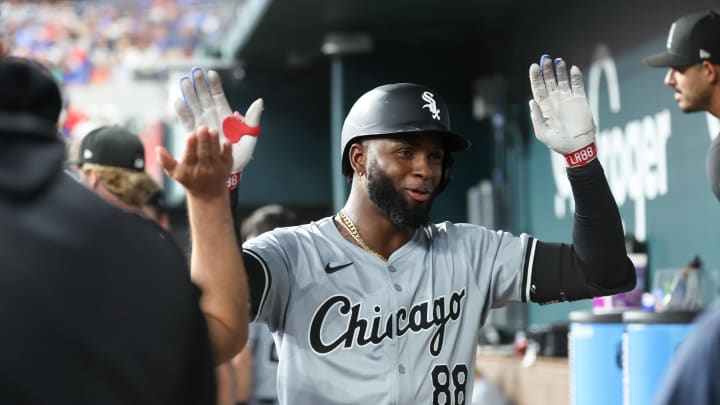 Chicago White Sox center fielder Luis Robert Jr. (88) celebrates with teammates in the dugout after hitting a home run during the third inning against the Texas Rangers at Globe Life Field in 2024.