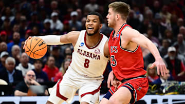 Mar 23, 2025; Cleveland, OH, USA; Alabama Crimson Tide guard Chris Youngblood (8) dribbles defended by St. Mary's Gaels guard Augustas Marciulionis (3) in the first half during the NCAA Tournament Second Round at Rocket Arena. Mandatory Credit: Ken Blaze-Imagn Images