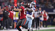 Dec 22, 2024; Arlington, Texas, USA; Dallas Cowboys wide receiver CeeDee Lamb (88) catches a pass against Tampa Bay Buccaneers cornerback Zyon McCollum (27) in the second quarter at AT&T Stadium. Mandatory Credit: Tim Heitman-Imagn Images