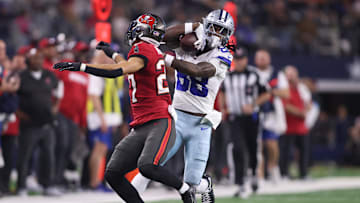 Dec 22, 2024; Arlington, Texas, USA; Dallas Cowboys wide receiver CeeDee Lamb (88) catches a pass against Tampa Bay Buccaneers cornerback Zyon McCollum (27) in the second quarter at AT&T Stadium. Mandatory Credit: Tim Heitman-Imagn Images