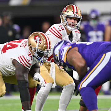 Oct 23, 2023; Minneapolis, Minnesota, USA; San Francisco 49ers quarterback Brock Purdy (13) controls the offense as offensive tackle Spencer Burford (74) prepares to block against the Minnesota Vikings during the first quarter at U.S. Bank Stadium. Mandatory Credit: Jeffrey Becker-Imagn Images