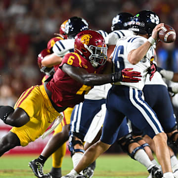 Sep 7, 2024; Los Angeles, California, USA; USC Trojans defensive end Anthony Lucas (6) attempts to sack Utah State Aggies quarterback Bryson Barnes (16) during the second quarter at United Airlines Field at Los Angeles Memorial Coliseum. Mandatory Credit: Jonathan Hui-Imagn Images