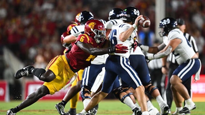 Sep 7, 2024; Los Angeles, California, USA; USC Trojans defensive end Anthony Lucas (6) attempts to sack Utah State Aggies quarterback Bryson Barnes (16) during the second quarter at United Airlines Field at Los Angeles Memorial Coliseum. Mandatory Credit: Jonathan Hui-Imagn Images