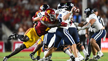 Sep 7, 2024; Los Angeles, California, USA; USC Trojans defensive end Anthony Lucas (6) attempts to sack Utah State Aggies quarterback Bryson Barnes (16) during the second quarter at United Airlines Field at Los Angeles Memorial Coliseum.