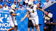 Aug 30, 2025; Lexington, Kentucky, USA; Toledo Rockets quarterback Tucker Gleason (4) celebrates with wide receiver Cooper Rusk (13) after scoring a touchdown during the fourth quarter against the Kentucky Wildcats at Kroger Field. Mandatory Credit: Jordan Prather-Imagn Images