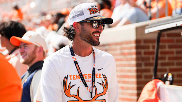 Tennessee baseball coach Tony Vitello smiles on the sidelines during a NCAA football game between Tennessee and Georgia
