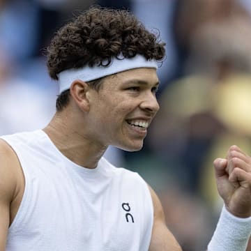 Ben Shelton celebrates winning a Wimbledon match.