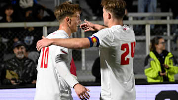 Denver midfielder Sam Bassett (10) reacts with forward Ian Smith (24) after scoring a goal  