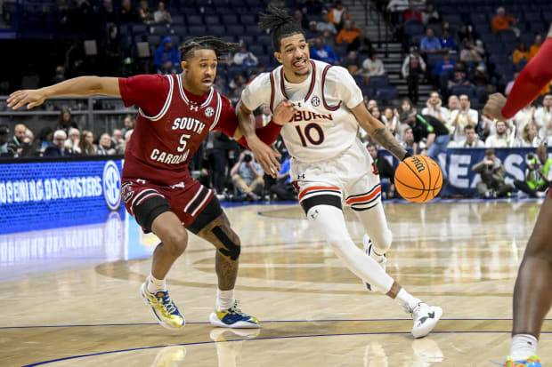 Basketball player defends a player driving down the lane.