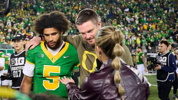 Nov 14, 2025; Eugene, Oregon, USA; Oregon Ducks quarterback Dante Moore (5) and head coach Dan Lanning talk to a reporter after a game against the Minnesota Golden Gophers at Autzen Stadium. Mandatory Credit: Troy Wayrynen-Imagn Images