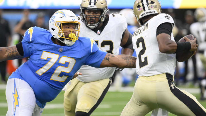 Aug 20, 2023; Inglewood, California, USA; Los Angeles Chargers defensive tackle Jerrod Clark (72) chases down New Orleans Saints quarterback Jameis Winston (2) during the first quarter at SoFi Stadium. Mandatory Credit: Robert Hanashiro-USA TODAY Sports