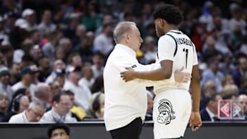 Mar 21, 2025; Cleveland, OH, USA; Michigan State Spartans head coach Tom Izzo talks with Michigan State Spartans guard Jase Richardson (11) in the first half against the Bryant University Bulldogs during the NCAA Tournament First Round at Rocket Mortgage Fieldhouse. Mandatory Credit: Rick Osentoski-Imagn Images